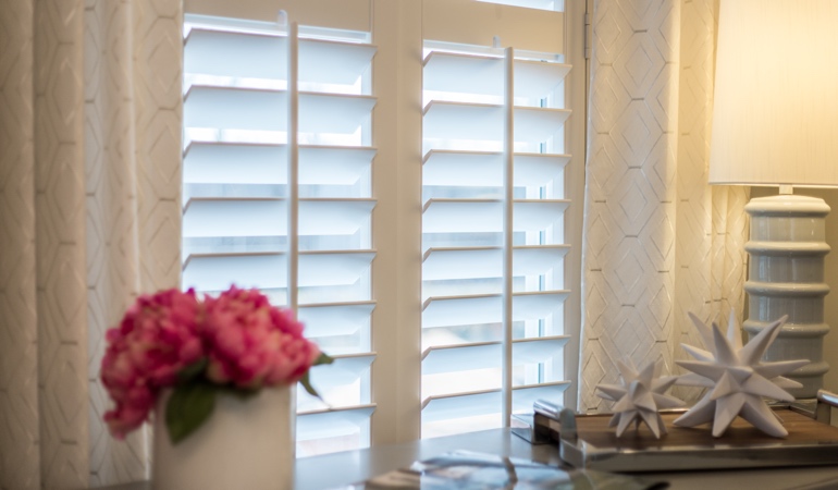 Plantation shutters by flowers in Denver